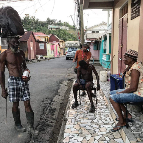 People sitting on a street corner in a residential area