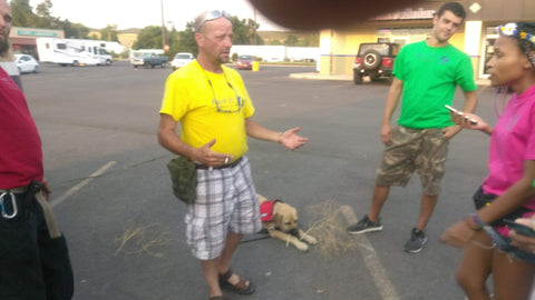 Group of people in a parking lot with a dog