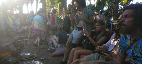 People gathered outdoors, possibly at a festival or event, with a focus
