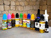 Bottles containing various anointing oils with colorful labels and dropper tops, arranged side by side in old Jerusalem setting.