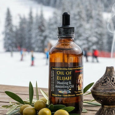 Bottle of oil of Elijah with olives and a smoking incense burner on a wooden platform with a snowy mountain background