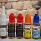 Collection of various essential oil bottles with colorful caps on a stone surface.